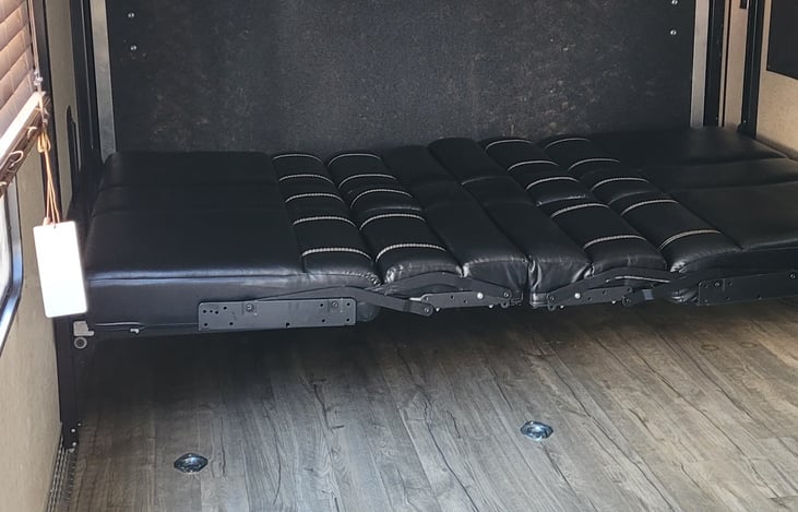 dinette makes to a bed with queen bed above