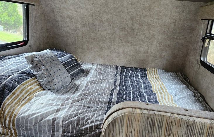 Rest easy on a clean queen bed with a extra thick mattress topper with fresh linens provided — comfort and convenience included for a good night’s sleep on the road.