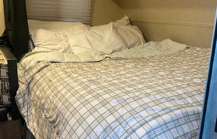 Queen master bed with privacy curtain. Includes memory foam pad for extra comfort