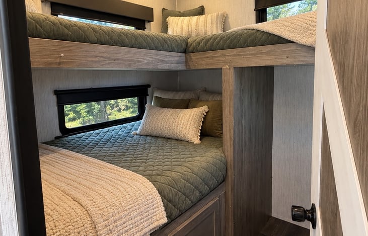 Each bunk has clean sheets, bedspread and pillows, Virtually staged