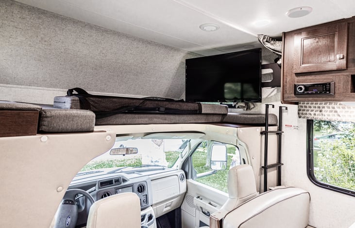 The kids will fight over this bunk! Has its own TV,  charging ports, two windows, and a safety net!