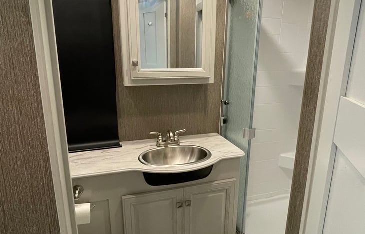 Beautiful bathroom with walk in shower, extra storage and plenty of counter space.