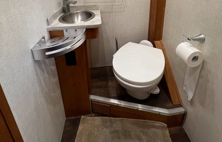 Toilet area with above storage for your toiletry storage.