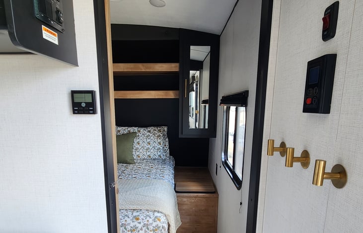 View from entrance looking into private bedroom. Has sliding door to close. Also equipped with 3 gold hooks for your purse, sweaters or keys.