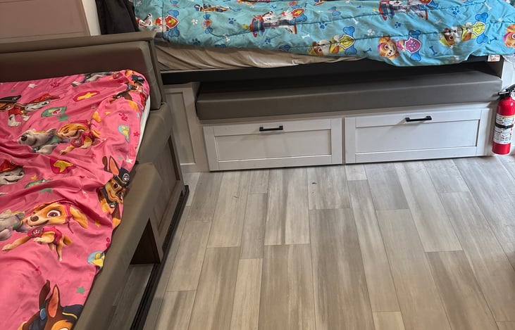 Queen size bed and twin size bed which is also dinning table.