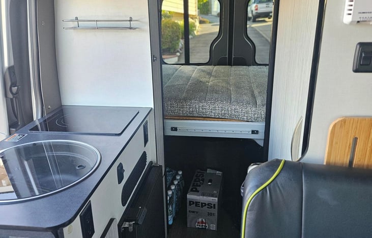 The stove is a conduction unit. Appropriate pots and pans are provided. There is also toaster oven provided and a small blender and a coffee pot. There are also utensils and dishware.