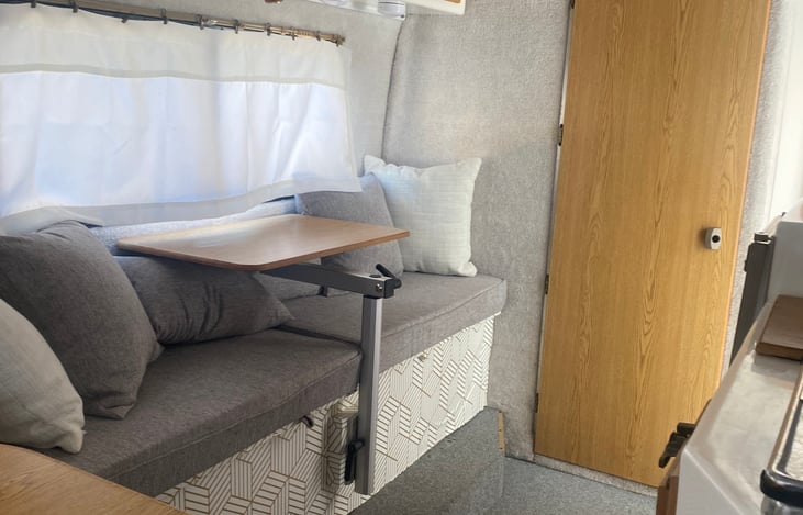 Casita interior storage bench/work bench view. The work desk swivels or can be removed completely for easy lounging and lots of storage above and below the bench.