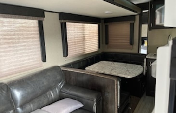 Slide out with dining room table hat turns into a bed. Couch that also turns into full bed.