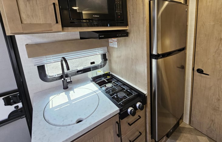 Small kitchen with large fridge becomes a great prep area for the outdoor kitchen!