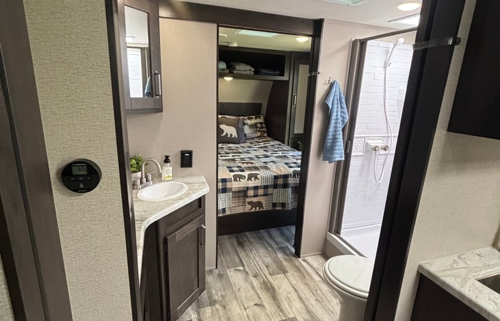 Walk through bathroom with sliding doors.