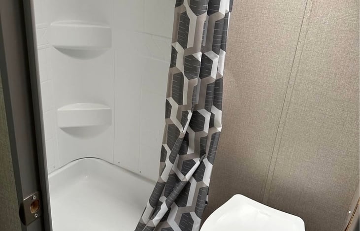 Roomy shower and flush toilet. We provide RV suitable toilet paper and bath linens.