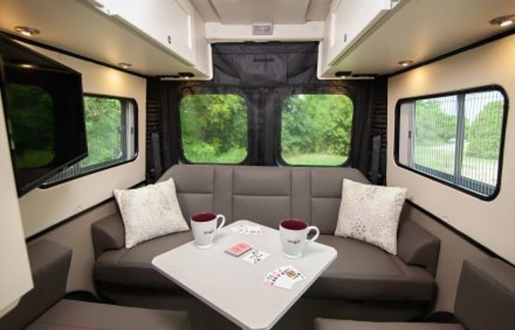 Rear hang out and dining area with power sofa and removable swivel table; this converts into a king bed