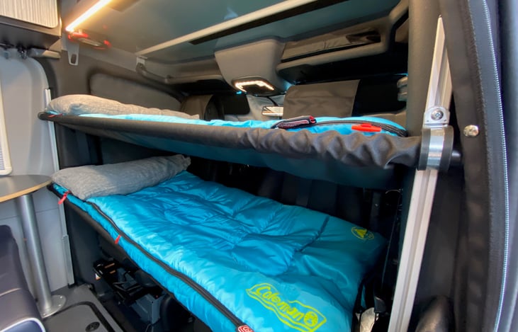 Bunk beds in the cab of the van. They are 62 inches long. (5'2")