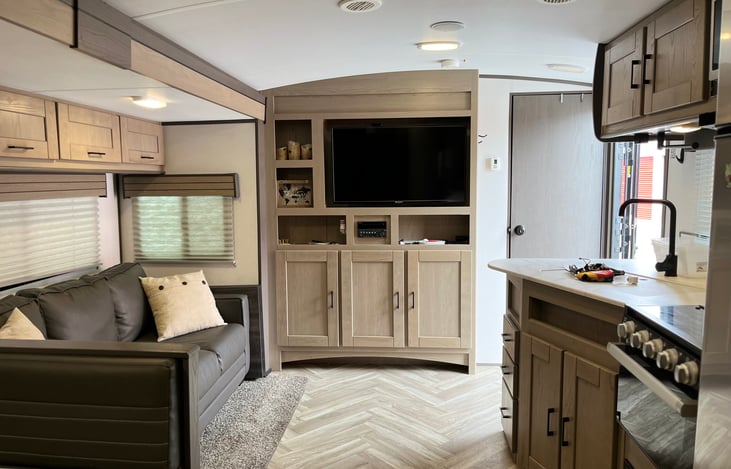 TV, DVD, CD player, and AM/FM radio, Bluetooth speakers in the living area and outside the RV. Slide-out allows for a spacious living area.
