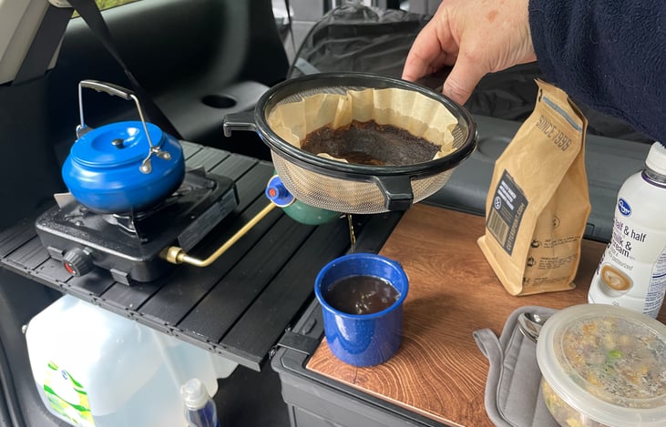 Coffee filter in strainer makes a tasty cup of brew.  Food just tastes better outside.