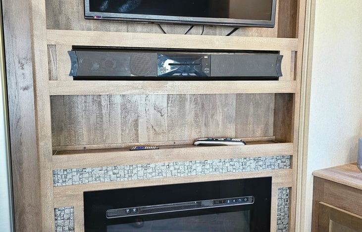 Living room area with TV, fireplace, dvd player, surround sound