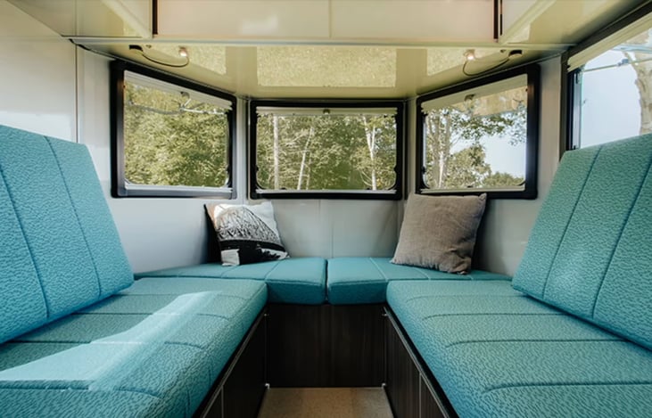 Mid trailer looking backwards. A table can be put between the bench seats, used as two twin beds, and / or made into an oversize king bed. Perfect for a couple and their favorite pet!