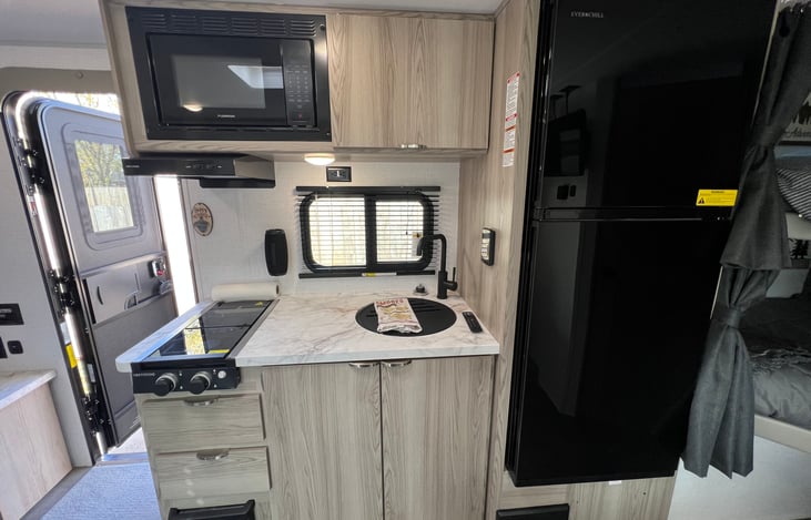 Kitchen complete with stove top, microwave, sink, and fridge. Cabinets will provide you with nearly all supplies you will need.