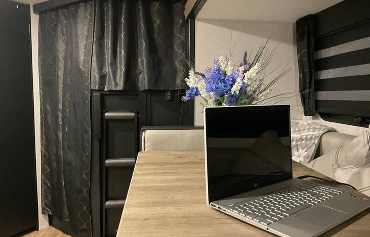 View of upper and lower double-bunks with privacy curtain pulled. (Laptop is not included with rental.)