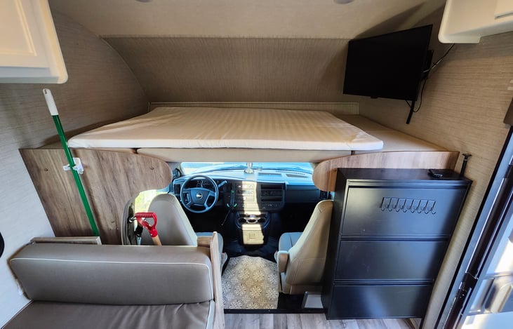Overhead cab bunk: TV, full size mattress topper, shot ski!