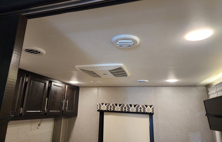 Main bedroom AC unit and cabinet storage spaces.