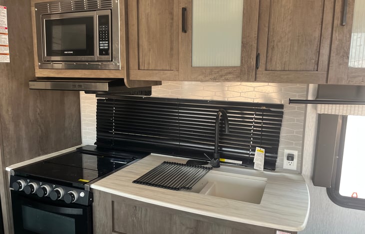 Microwave, stove and sink.