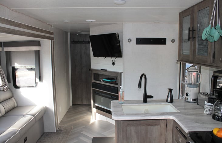 Living area with TV, electric fireplace and sound system