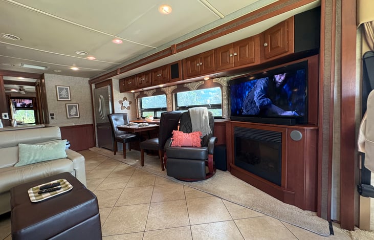 large flatscreen TV with a soundbar and a subwoofer