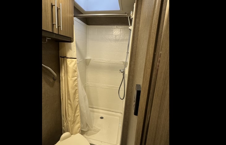 Shower. With sunroof, even people over 6' tall can easily stand in there!