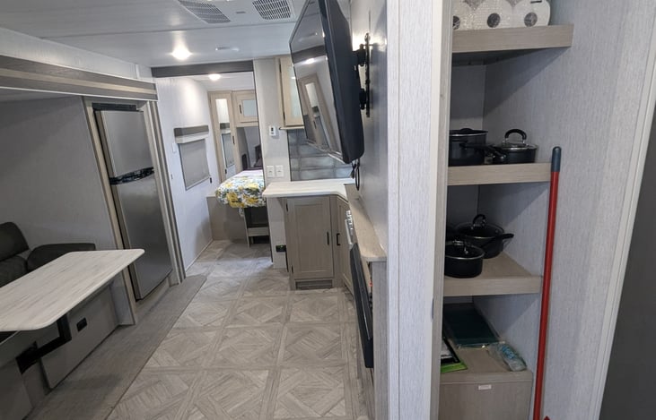 Pantry with cleaning supplies and cookware