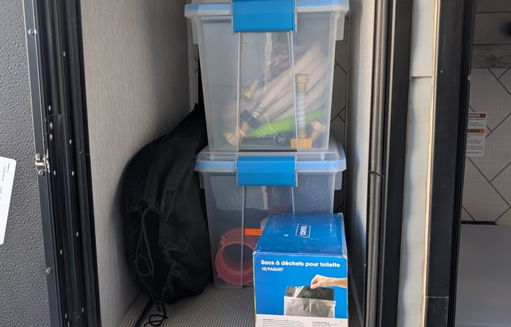 Storage area for supplies (Fresh water hoses & Black tank dump hoses)