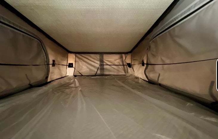 Pop up bed above camper
