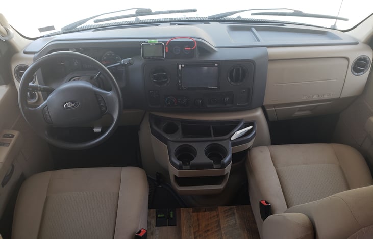 The Ford E450 cab dash has been modified to house the TPMS and 4 switch-controlled, lighted USB ports. There is a DVD player built-in to the dash as well.