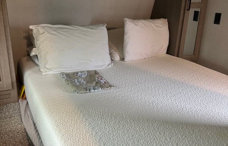 Queen Size plush memory foam mattress. with closing doors and small 22 inch TV and above bed 2nd AC unit.