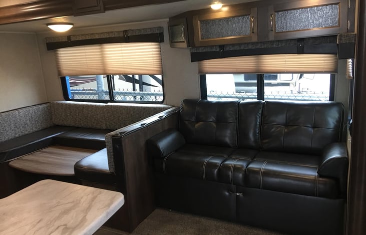 Dining room table lays down into a bed.  Couch can flip down for a bed.