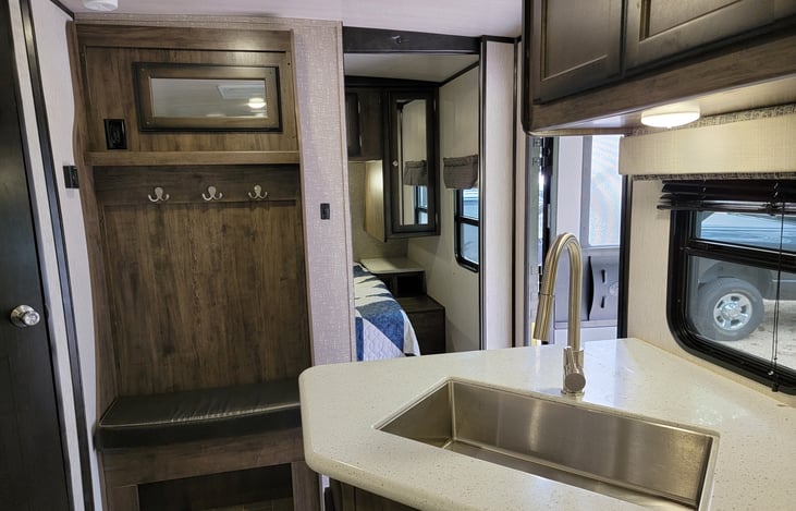 View of sink, master bedroom, and main door from the kitchen