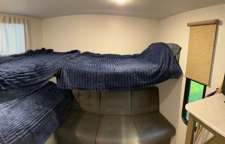 3 bunks with jack knife sofa.  Bunk above sofa hinges up out of the way and there is a smart tv in the opposite corner for those rainy days.