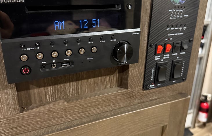 Indoor/Outdoor stereo system, controls for water heater, awning, and lights.