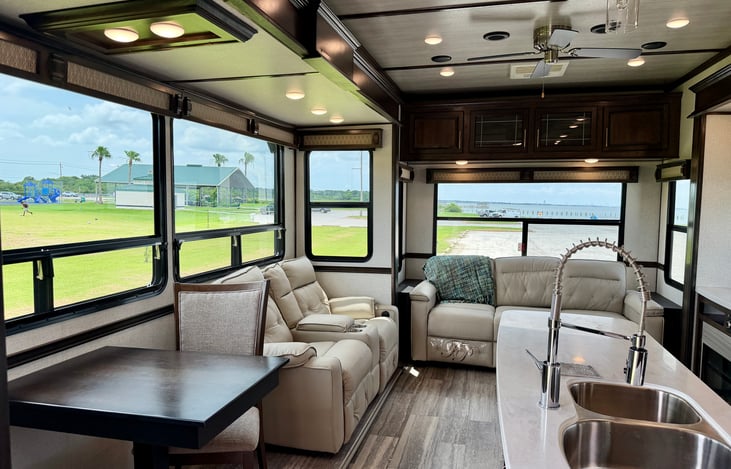Chef's Dream Kitchen: Residential central island with a dual basin sink, a 4-burner cooktop, an oversized convection microwave, and a free-standing dinette.
