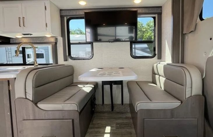 Lays down for bed.  Pillow and blanket will be available.  There are two seat belts .  One is a single child safety tether. Cup holders and Charging station.