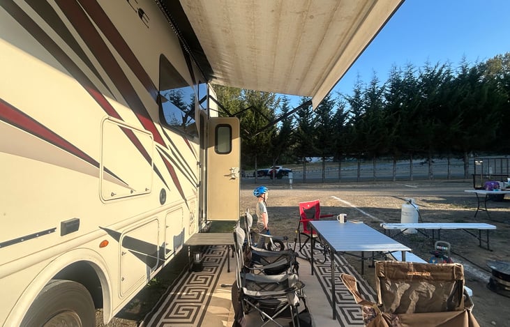 We have this large carpet, two chairs, and a metal table in the outdoor storage lockers.