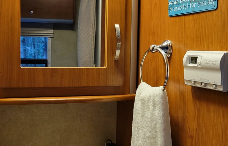 Comfort contol panel for heating with either propane or electric heat pump and air conditioning