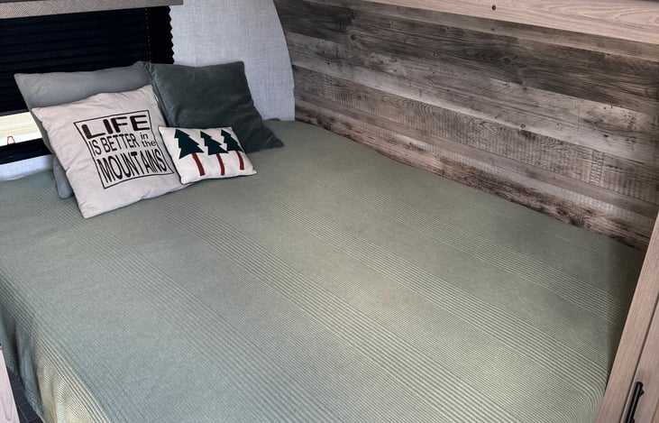 Queen bed with memory foam topper.