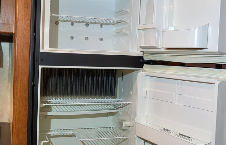 freezer and refrigerator with large storage cabinet above