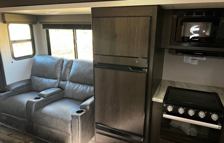 Recliners, fridge/freezer and propane stove/oven, microwave.