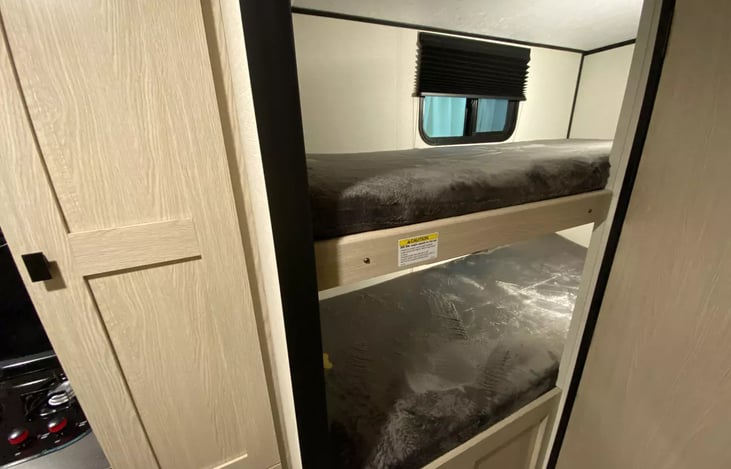 Bunkroom with two bunks (30" x 74").  More suitable for kids and teenagers but adults would find them comfortable too once situated.  Each bunk has a window, electrical outlet & a storage bin.