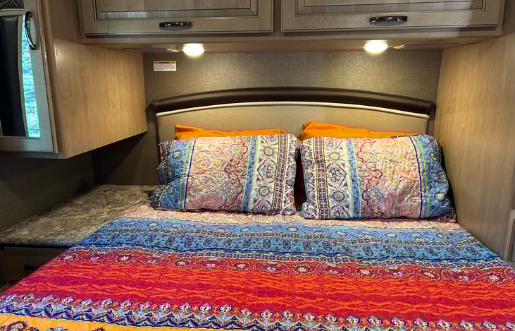 Rear extended queen bed, lighted storage space for your clothes on either side and above. Electric blankets included as well, TV, audio controls, privacy room divider, reading lights, 2 windows.