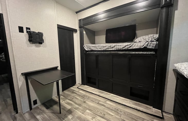Bunk house has a folding bunk bed to provide more space indoors on rain days as well as a table for activities.