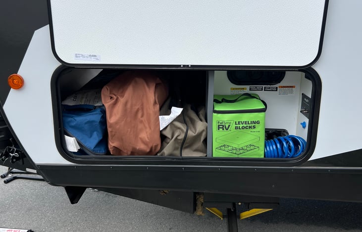 Connection for water, water fill up, exterior sink, tv hookups, electric stabilizer controls, leveling blocks. *2 Camping chairs and pop up tent available upon advanced request*