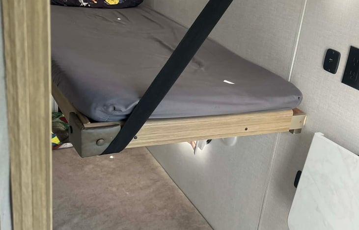 Bunkhouse. Top raises and lowers. Has sleeping pads for upper and lower